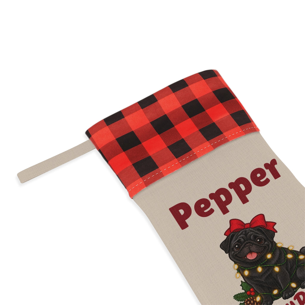 Close-up of the printed name Pepper under the red plaid cuff
