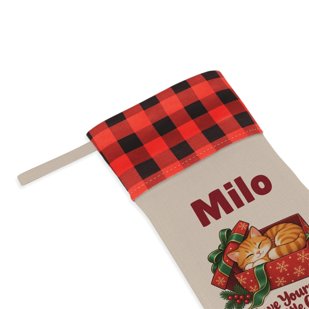 Close-up of the printed name Milo under the red plaid cuff
